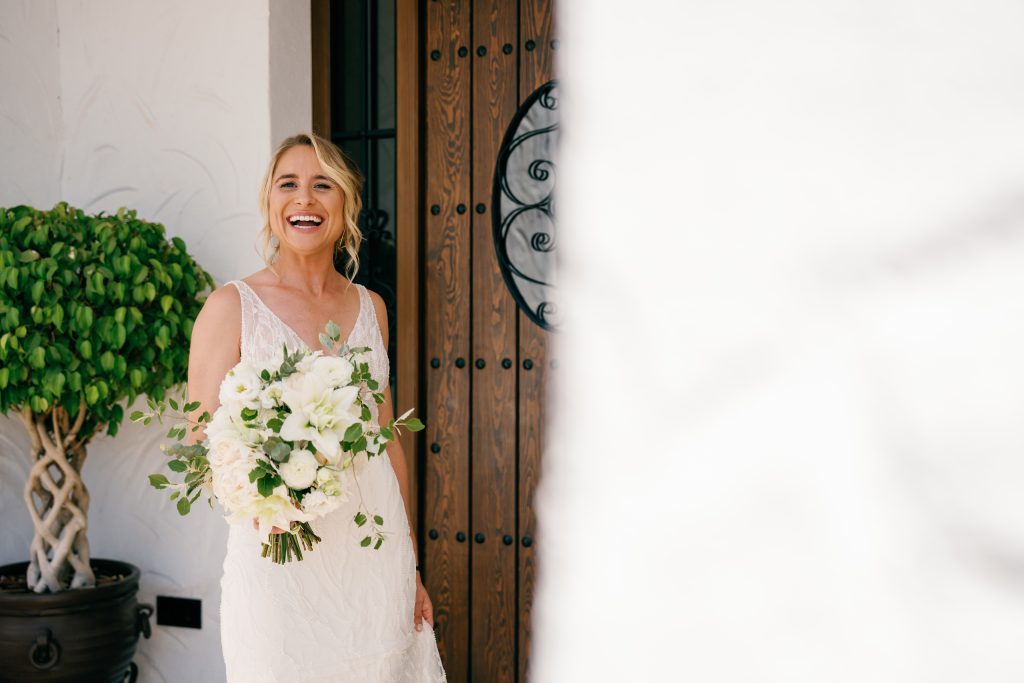Bride with her bouquet at the door, Casa de la Era wedding in Marbella