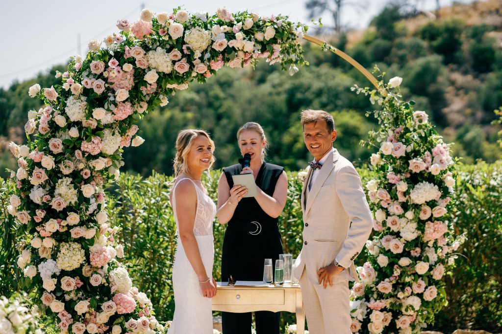 Couple under the flower arch at Casa de la Era, wedding in Marbella