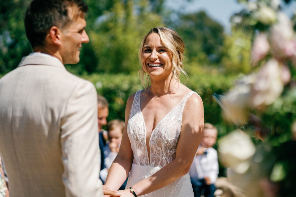 Couple holding hands under the flower arch, Casa de la Era wedding in Marbella