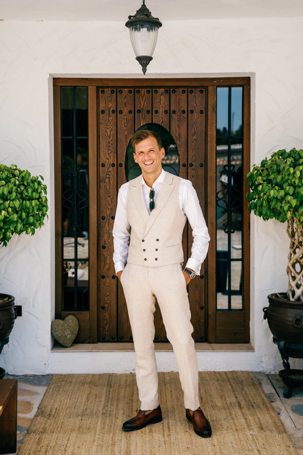 Groom getting ready by a wooden door, Casa de la Era wedding in Marbella