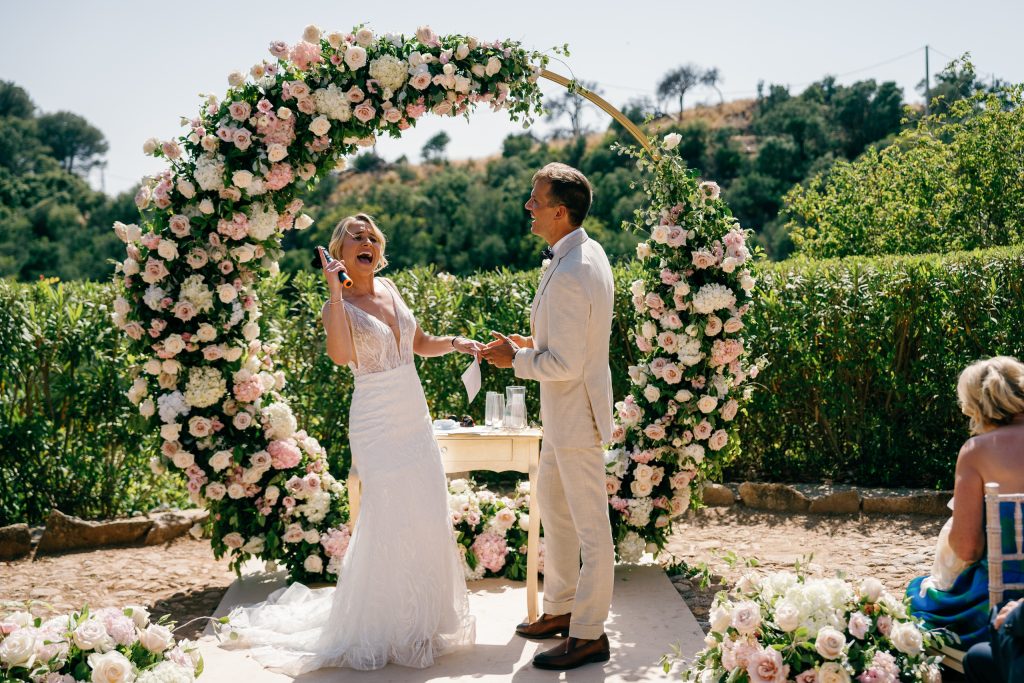 Ring exchange under the flower arch, Casa de la Era wedding in Marbella