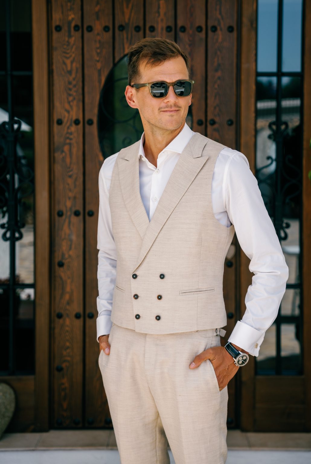 Groom waiting at the old wooden door, Casa de la Era wedding in Marbella