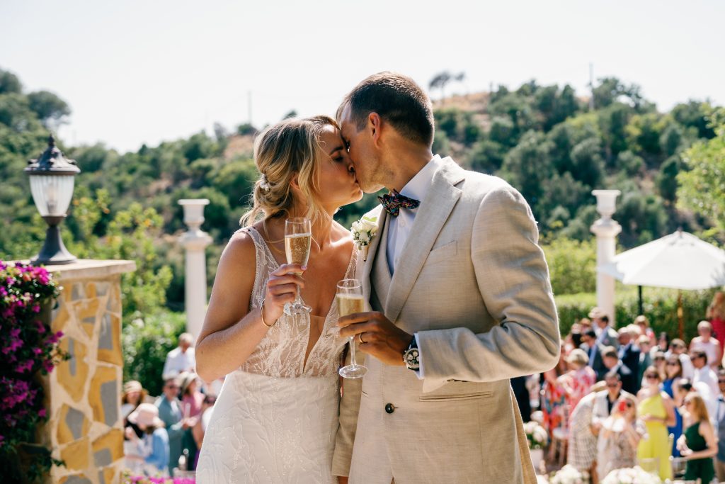 Couple kissing among their guests, Casa de la Era wedding in Marbella