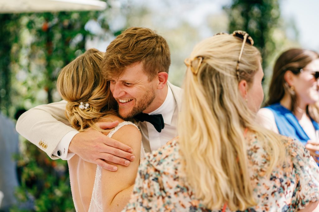 Groom hugging a guest, Casa de la Era wedding in Marbella