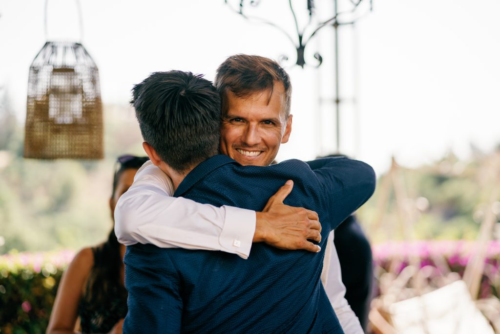 Warm hug between the groom and a guest, Casa de la Era wedding in Marbella