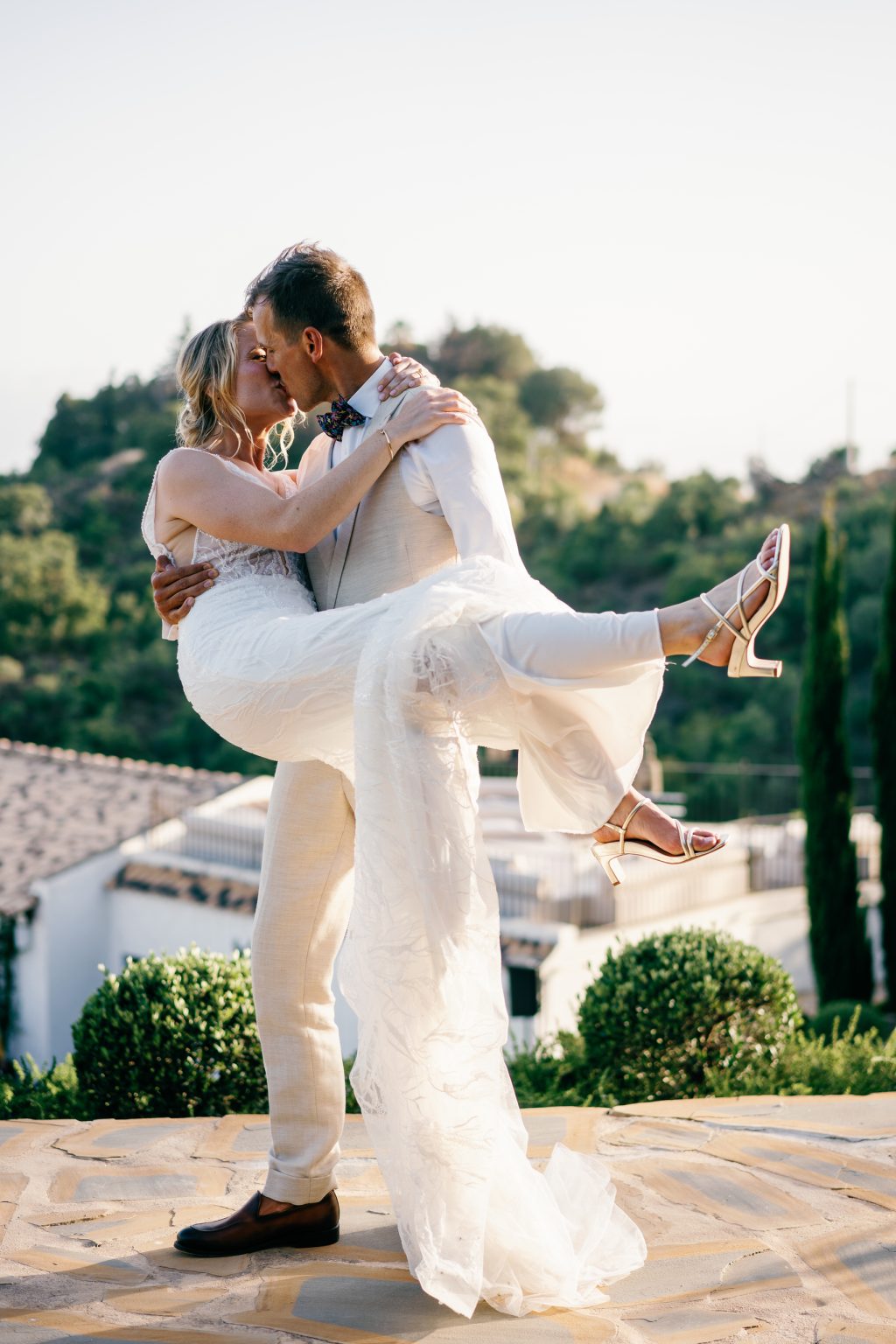 Groom carrying the bride and kissing her, Casa de la Era wedding in Marbella