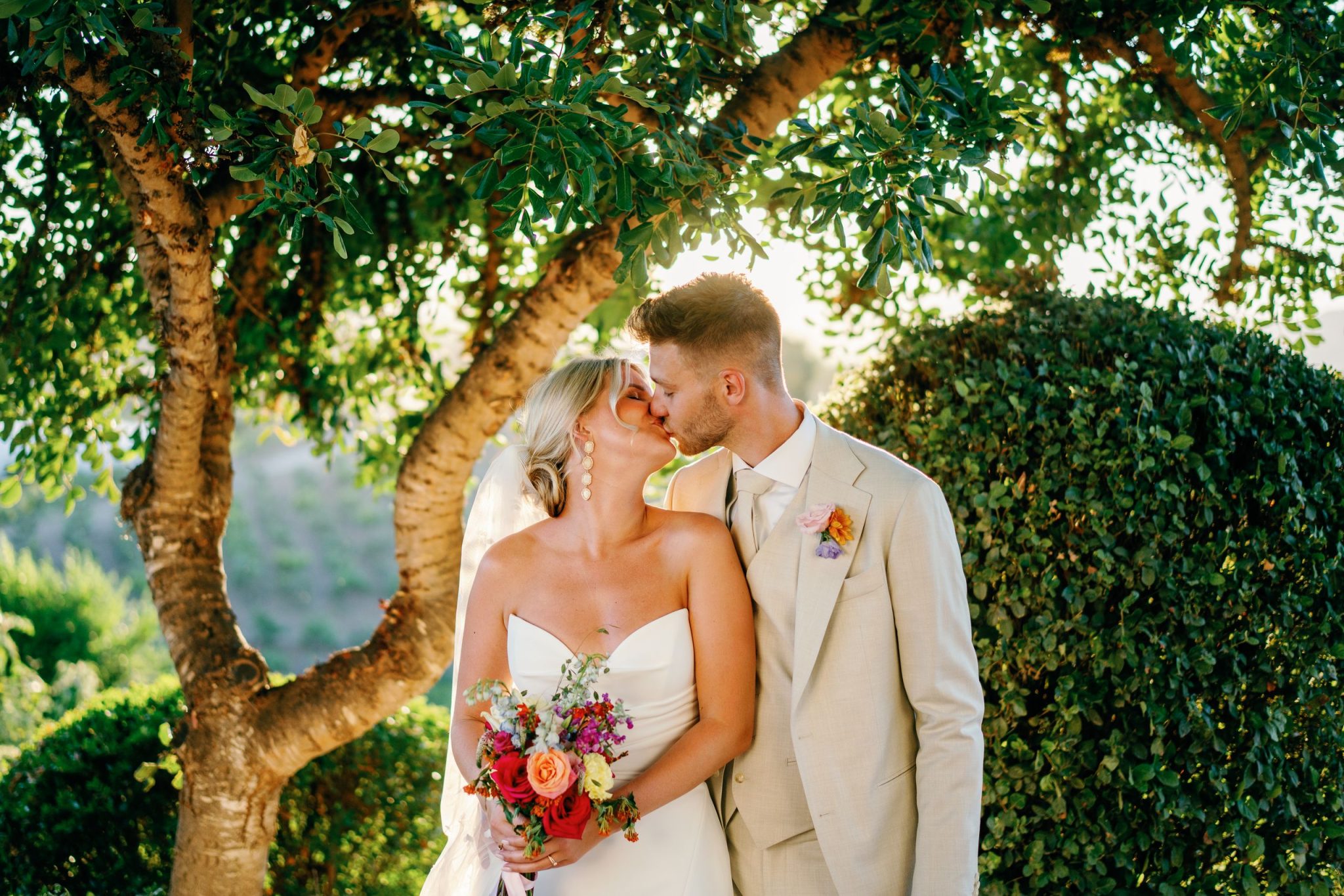 Couple under a tree in the gardens at sunset, Cortijo Bravo wedding near Nerja