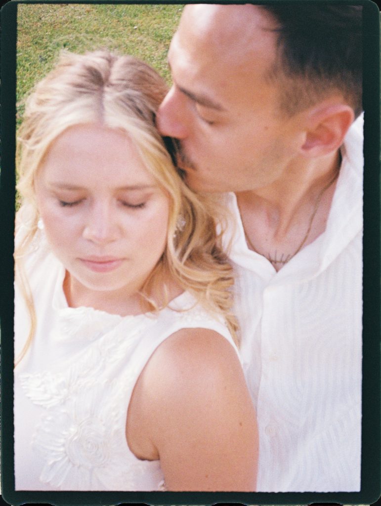 Groom kissing the bride's forehead, 35mm film wedding photo on the Costa del Sol