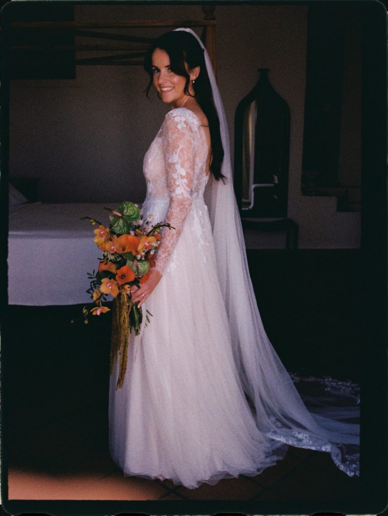 Bride with an orange bouquet in her room before the ceremony, 35mm film wedding photo on the Costa del Sol