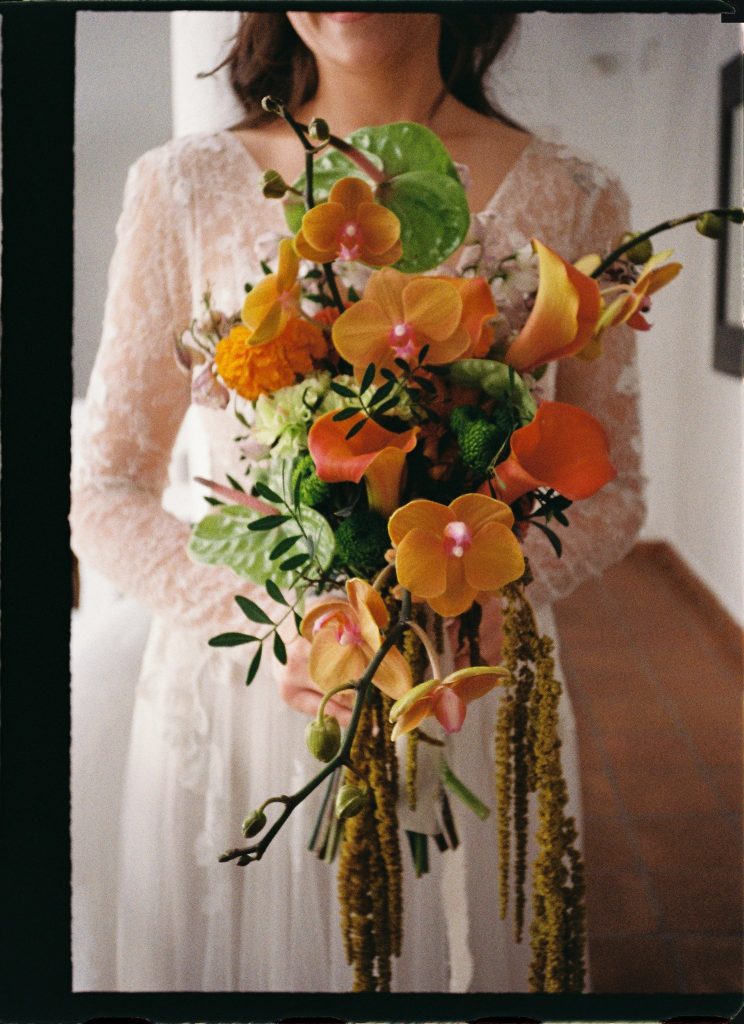 Close-up of an orange orchid bridal bouquet, 35mm film wedding photo on the Costa del Sol