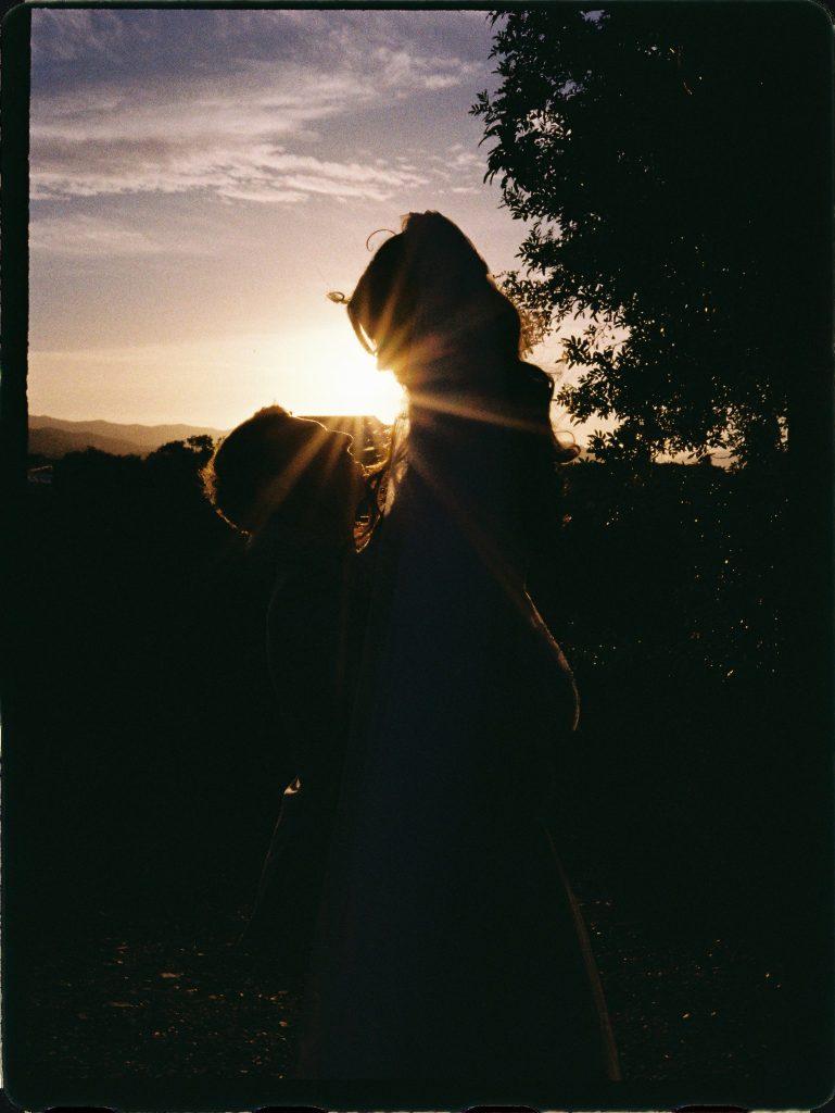 Couple silhouetted against the sunset, 35mm film wedding photo on the Costa del Sol