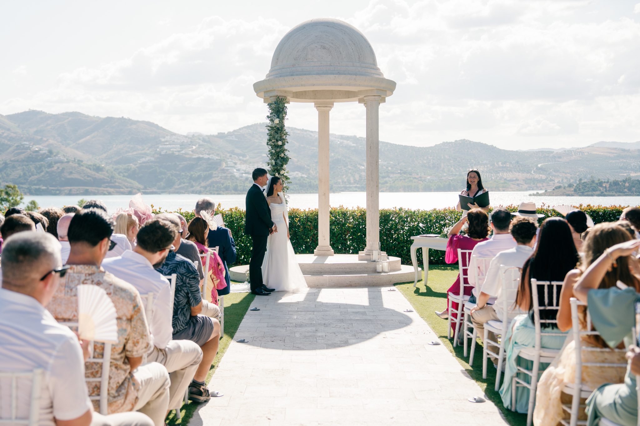 Outdoor wedding ceremony facing the lake and the mountains, Hotel La Viñuela wedding near Nerja