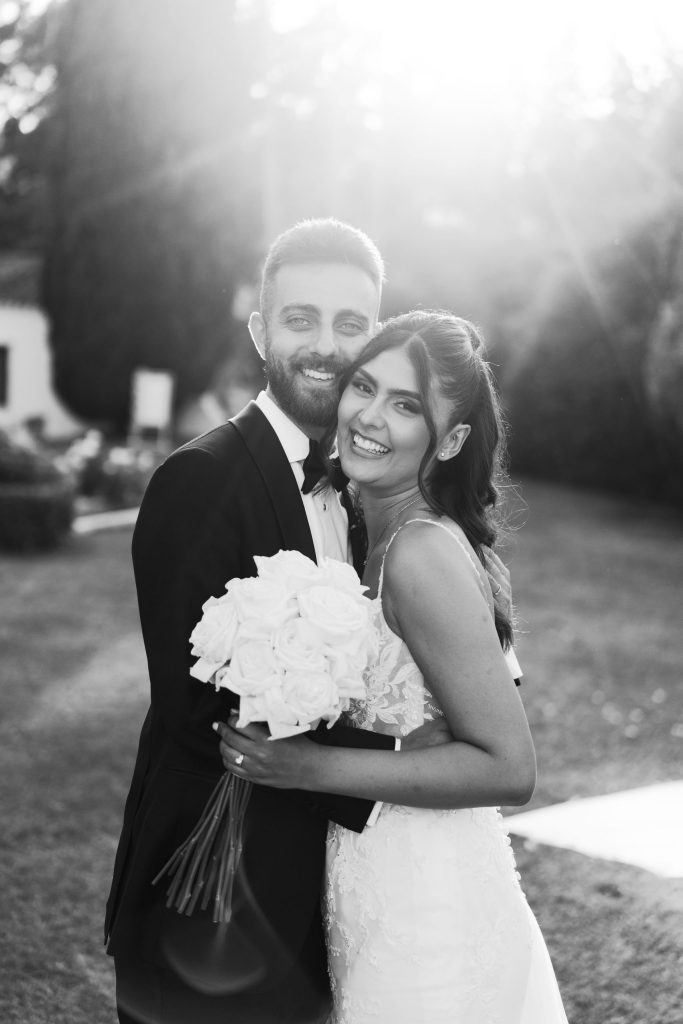 Groom hugging the bride, in black and white, Molino del Duque wedding in Manilva