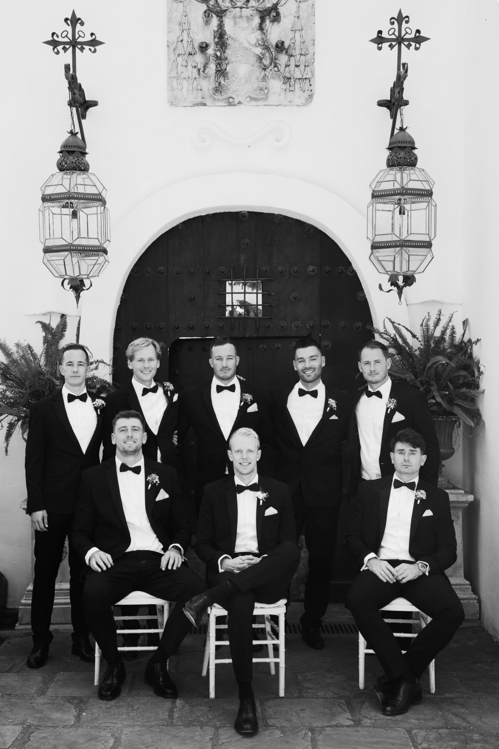 Black and white portrait of groomsmen in black tie at a wedding